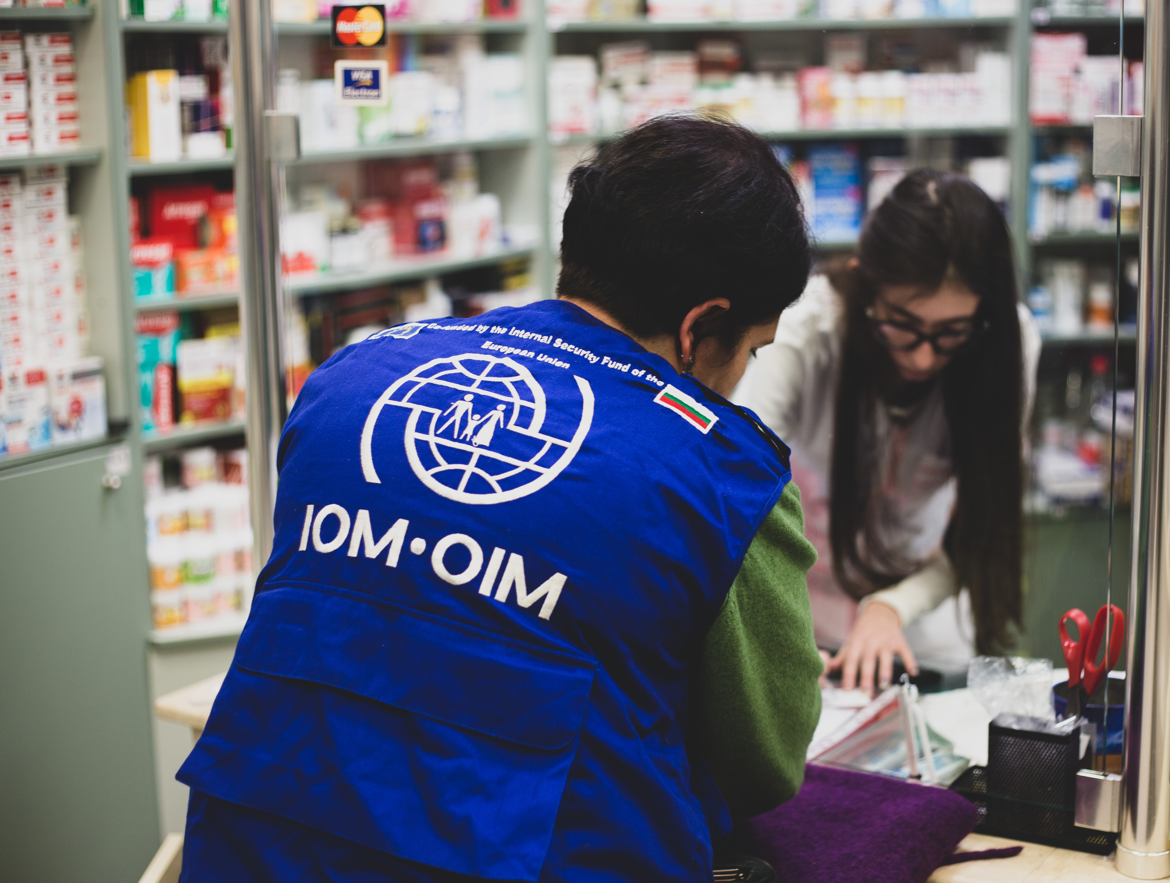 An IOM Bulgaria representative purchasing medicines in a pharmacy 